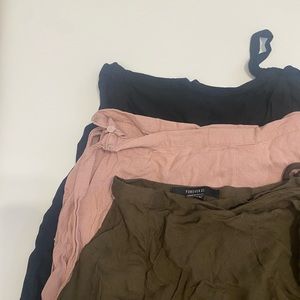 Three skirts one price. Never worn. Size small. Wrap around mini skirt.